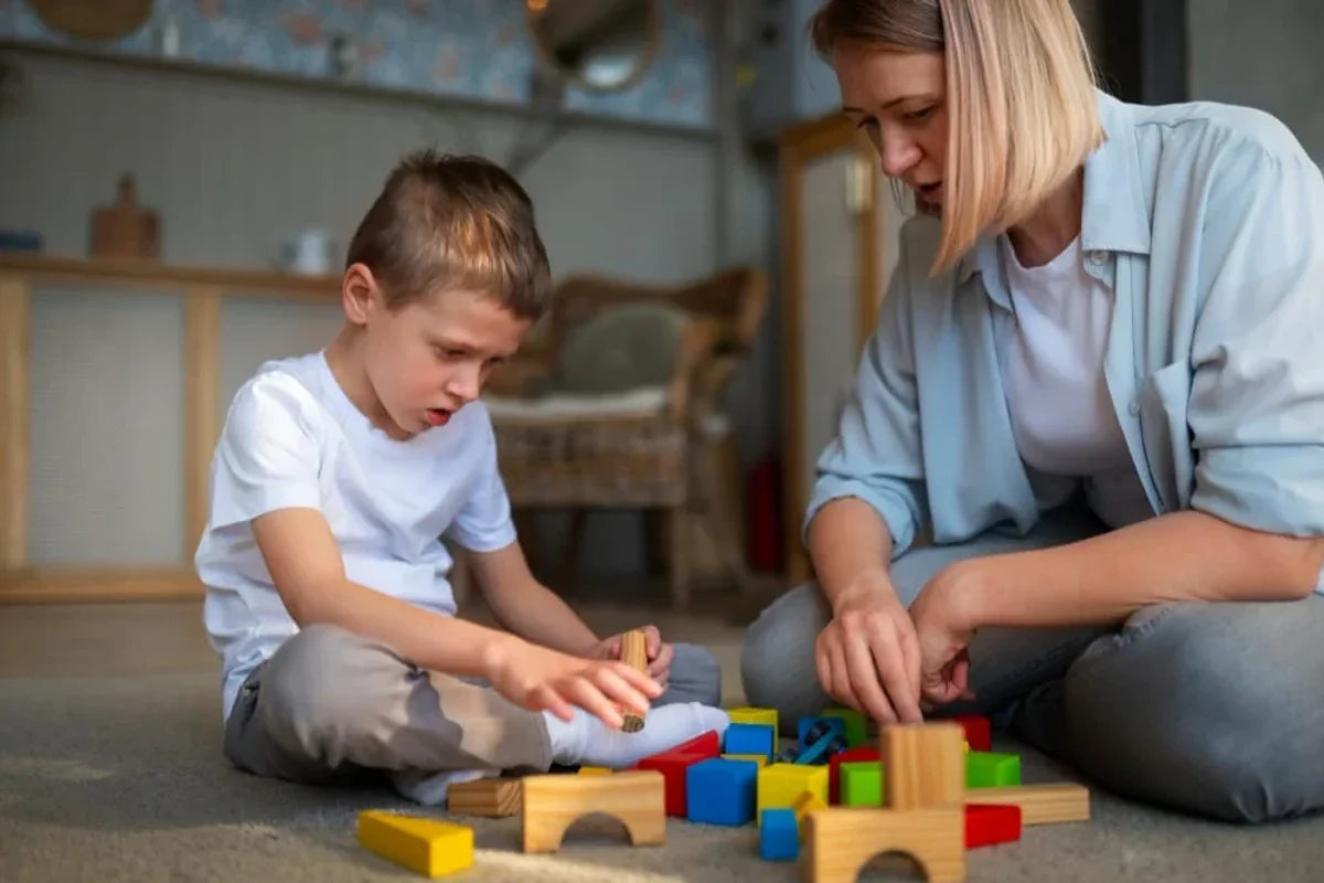 Woman and young boy playing with colorful blocks