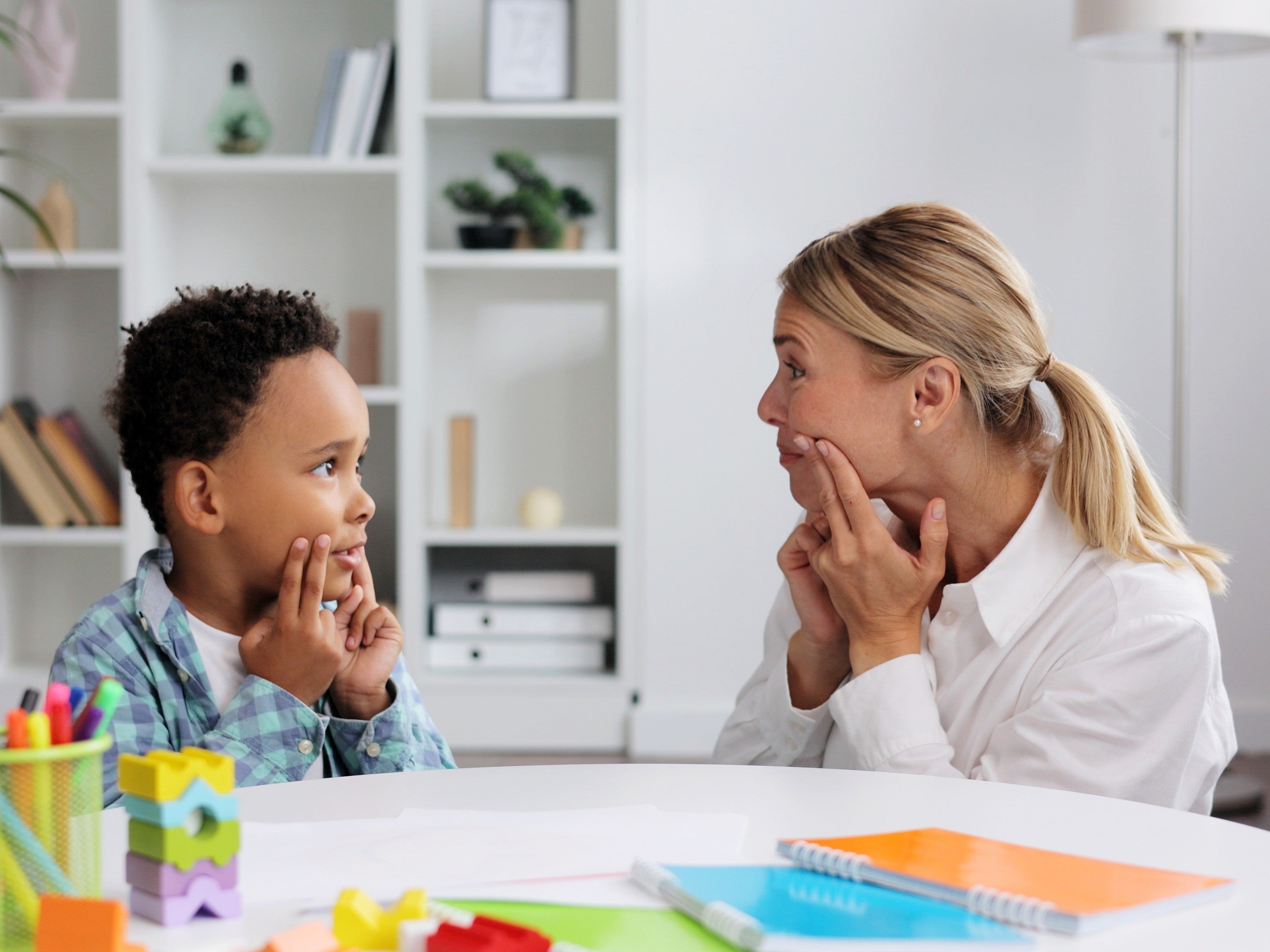 speech therapist and young boy in a session, showcasing how to get speech therapy for my child