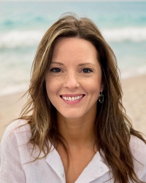 Amy Graham headshot smiling on the beach