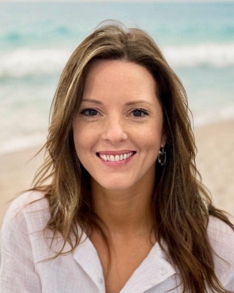Amy Graham headshot smiling on the beach