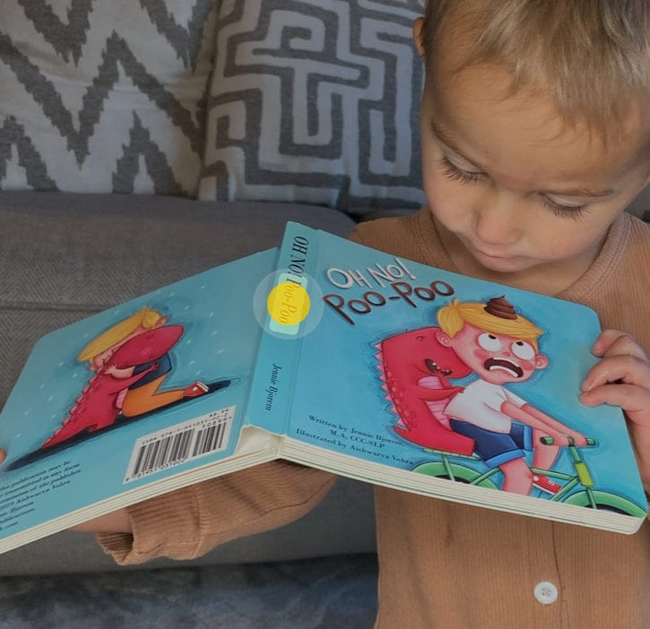 Child reading Oh No! Poo-Poo book, IMG_F5B4021A0EDA-1