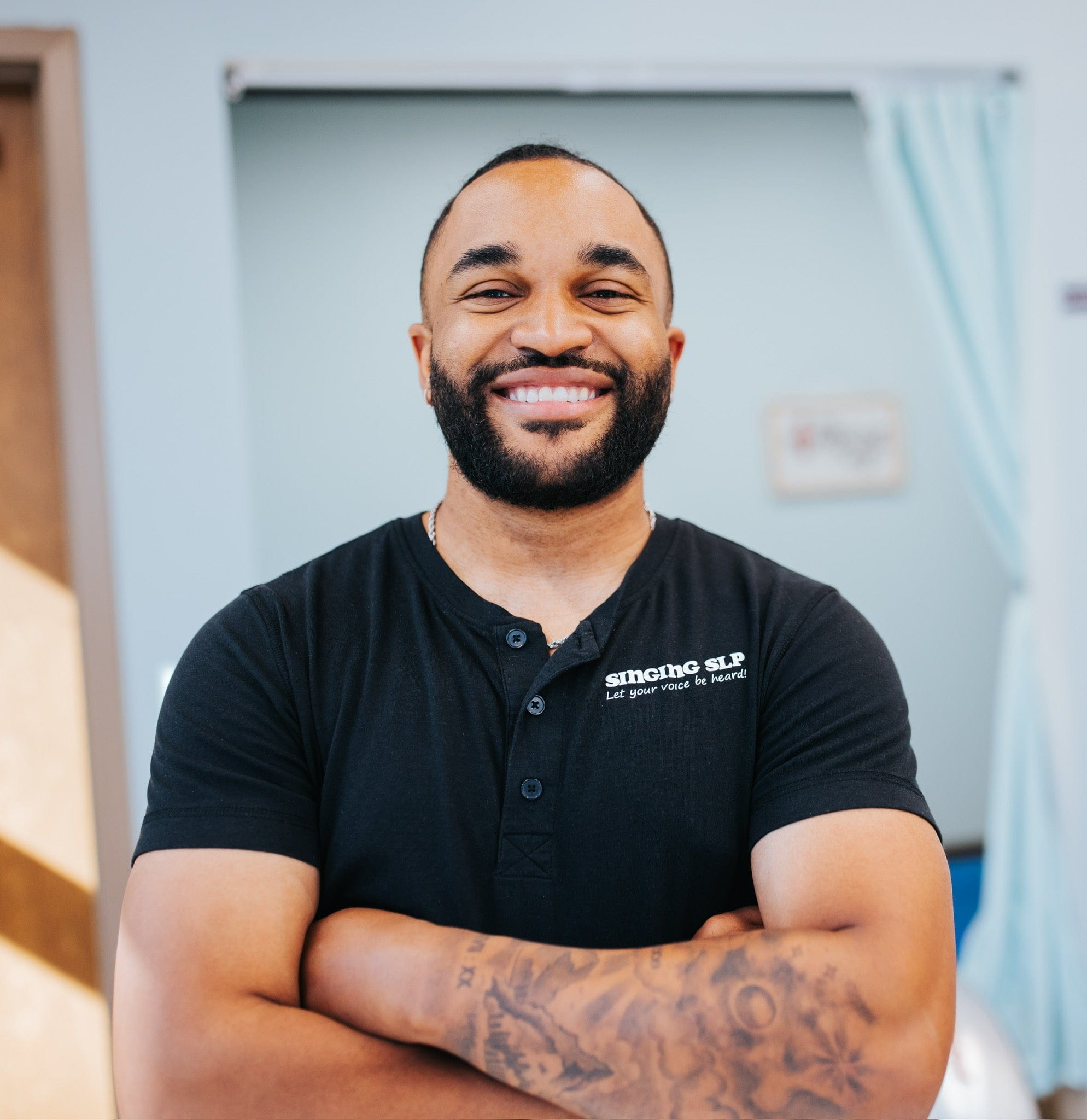 Kevin Simmons headshot, smiling with arms crossed