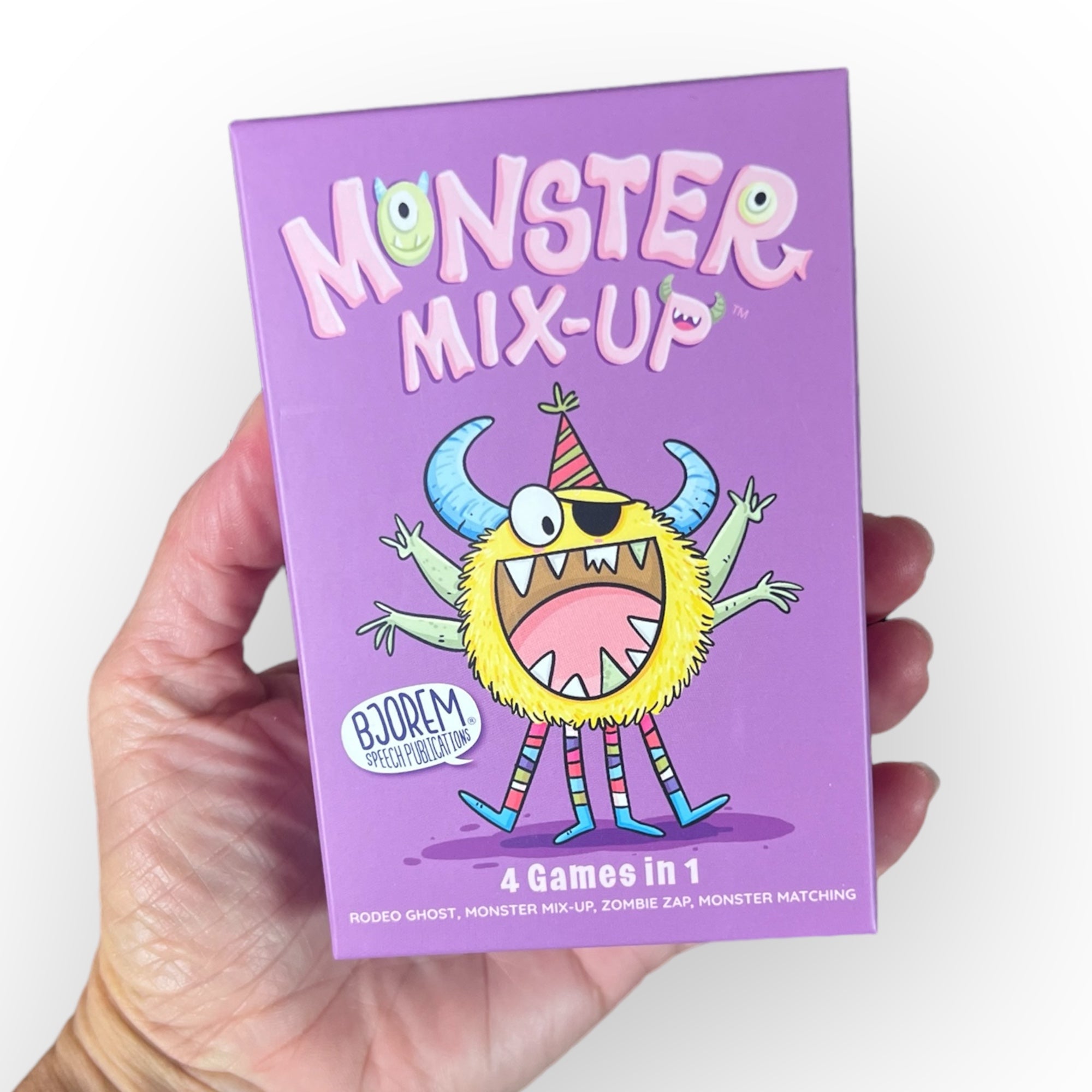 Hand holding Monster Mix-Up game box