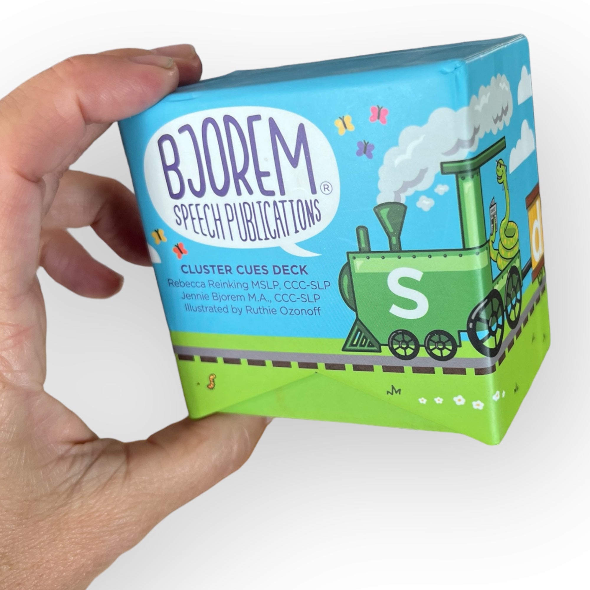 Bjorem Cluster Cues Deck held in hand, featuring a train illustration.