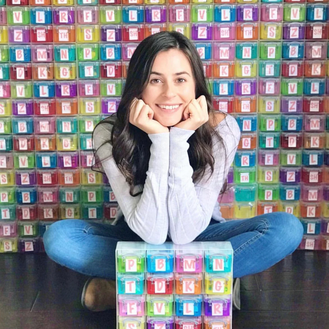 Woman in front of colorful storage containers, screenshot from May 8, 2025.
