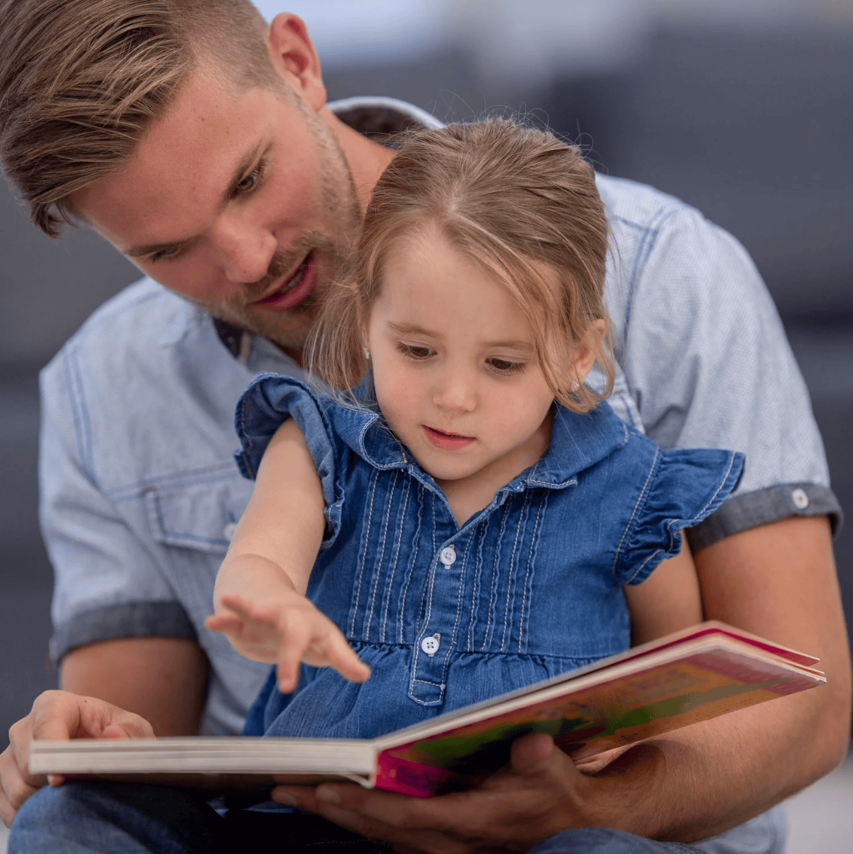 Father and daughter reading book, July 30, 2025