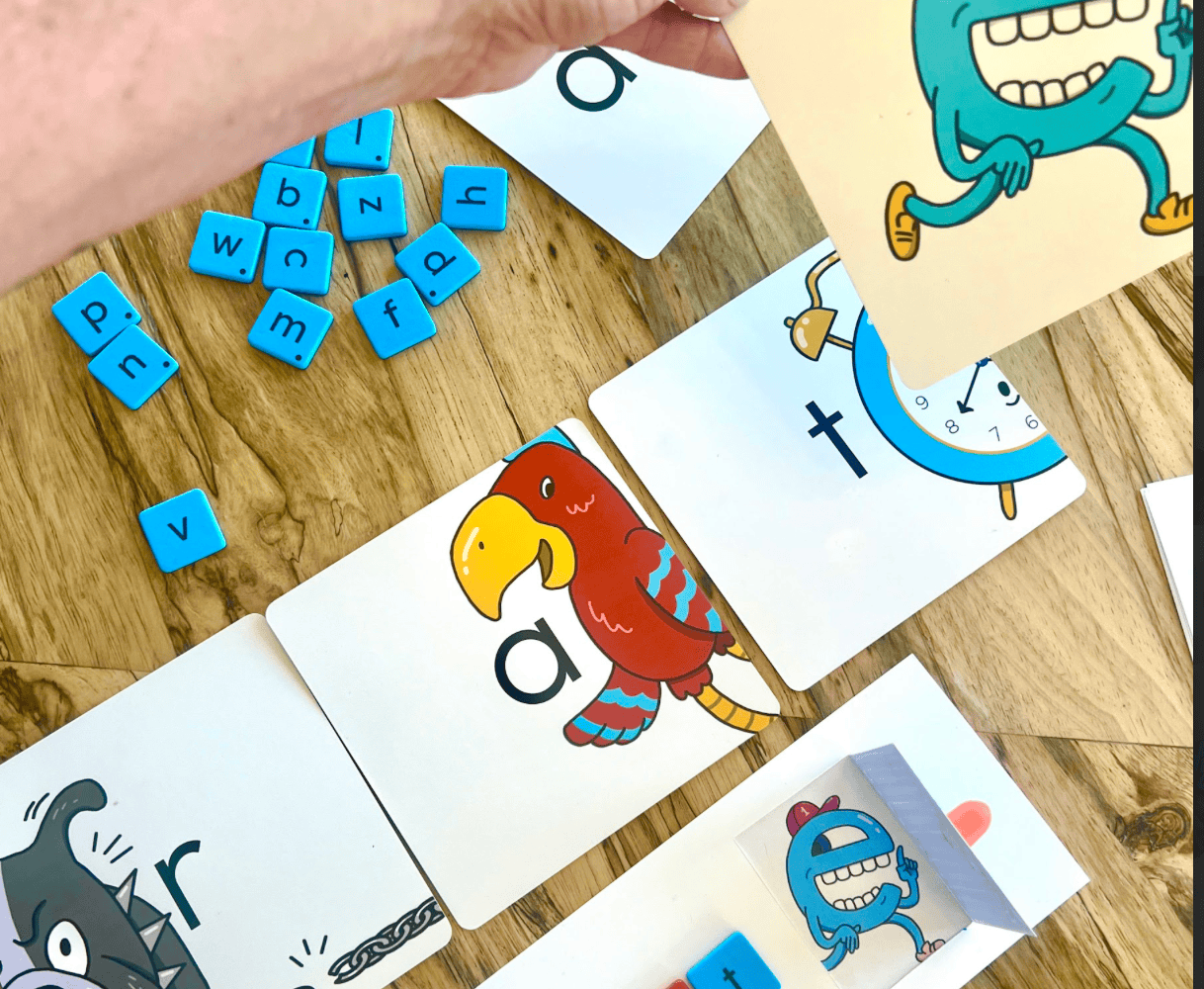 Phonics game with letter tiles and character cards