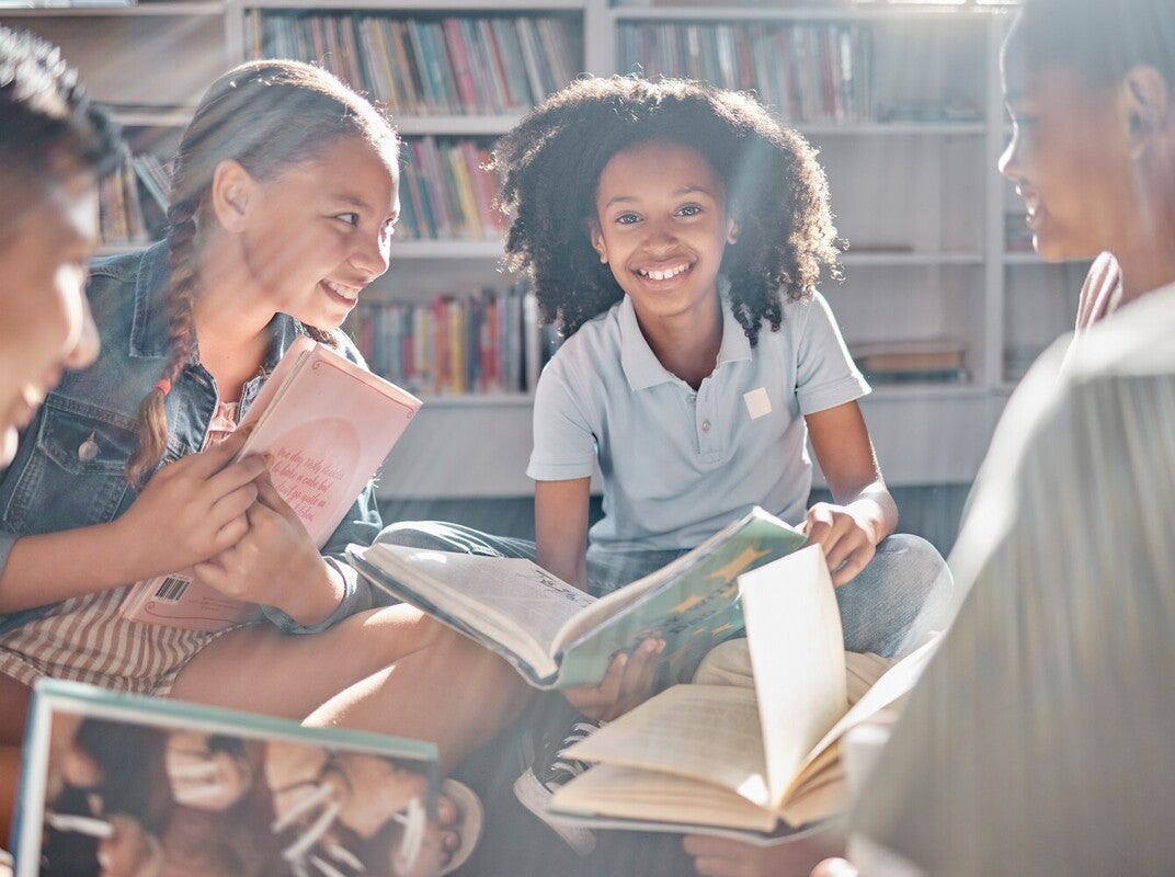 group of friends enjoying books together after their parents learned how to get kids interested in reading