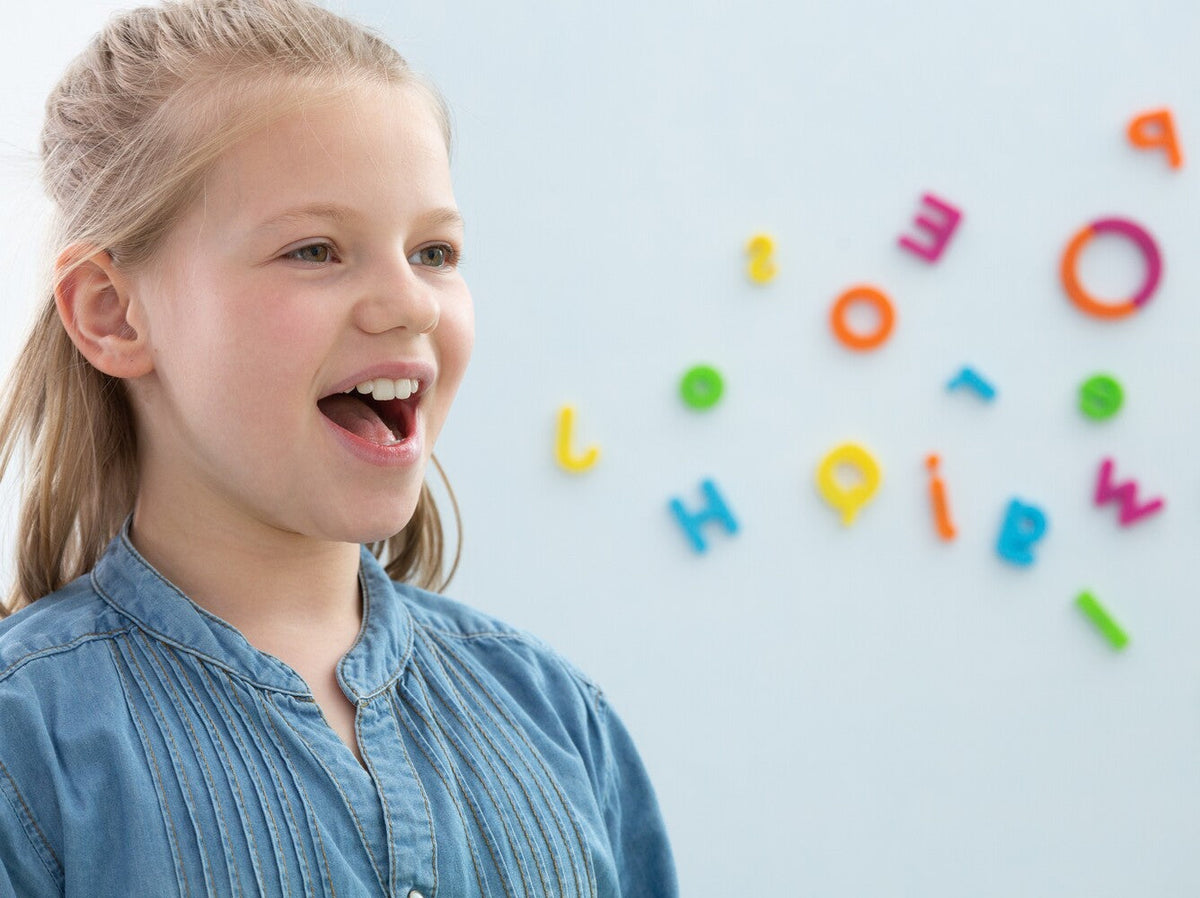 young girl with jumbled letters coming out of her mouth to represent speech disorders in children
