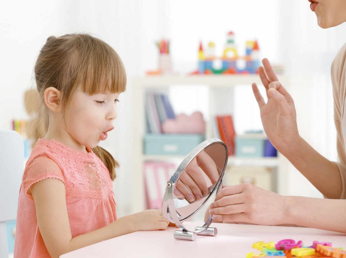 young girl working on her speech in speech therapy after displaying childhood apraxia of speech examples