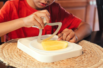 Child cutting food with the Totchop rocker knife