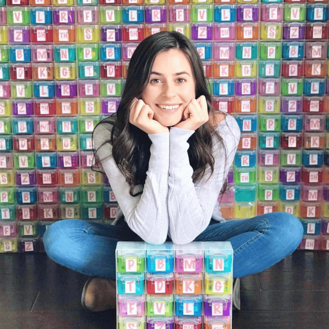 Woman in front of colorful storage containers, screenshot from May 8, 2025.